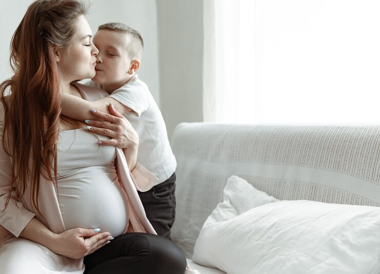 portrait-future-mother-with-her-little-son-embrace-copy-space_169016-11218